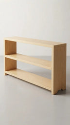Low wooden bookcase placed in a corner