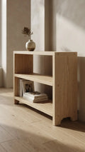 Handcrafted solid pine low bookcase with two open shelves and solid side panels, shown at an angle against a white background
